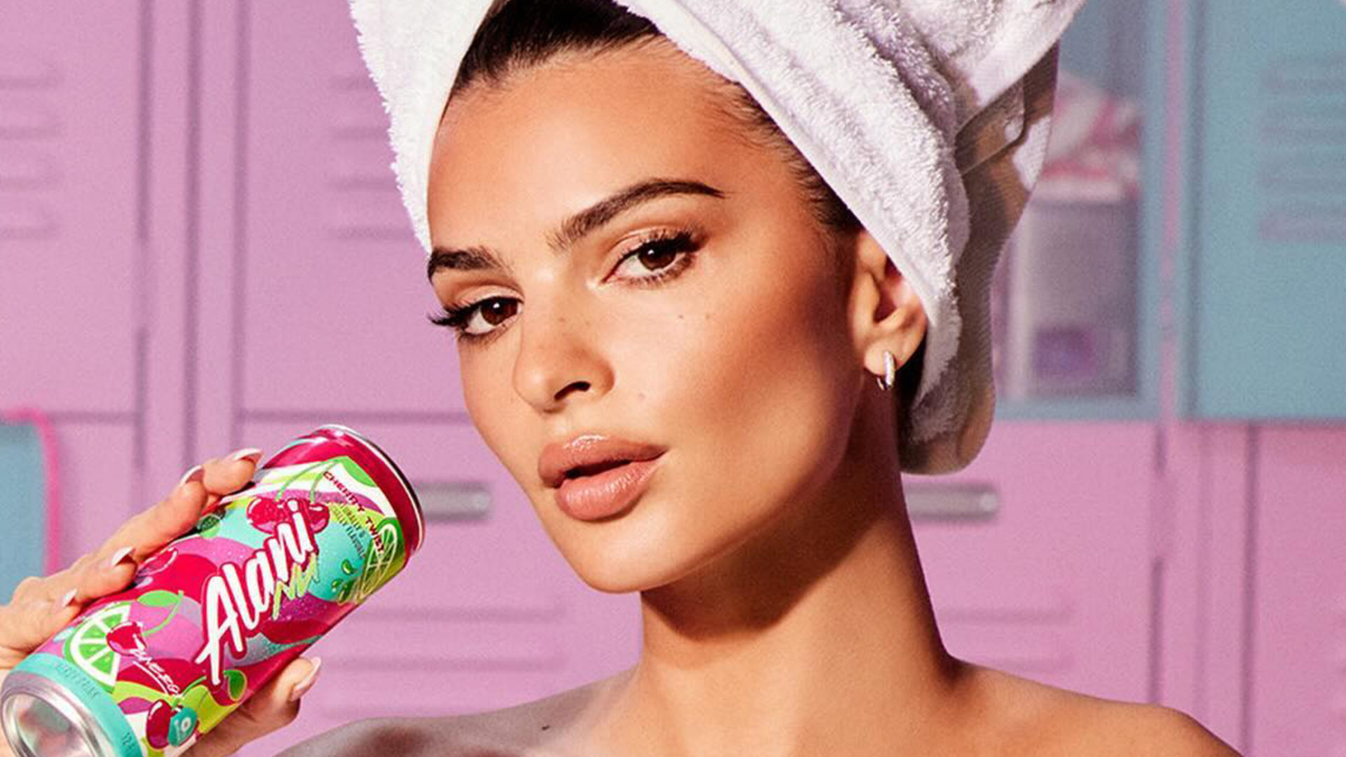 Emily Ratajkowski shows off bikini tan lines and wears just a tiny towel in gym locker room for new ad