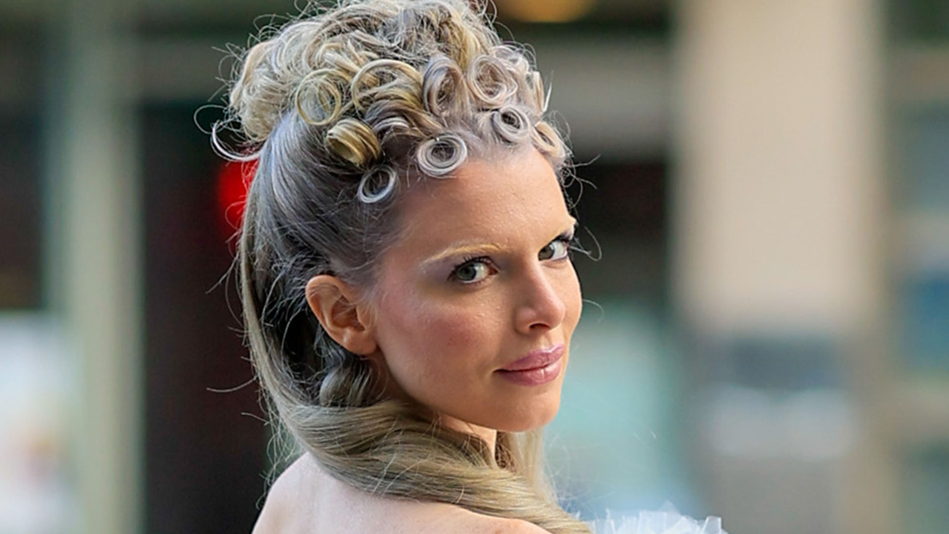 Julia Fox walks NYC streets in tight poodle-like dress featuring two giant furry balls and white heels