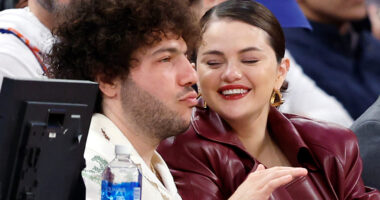 Selena Gomez and boyfriend Benny Blanco pack on the PDA as they cuddle up while courtside at Knicks versus 76ers game