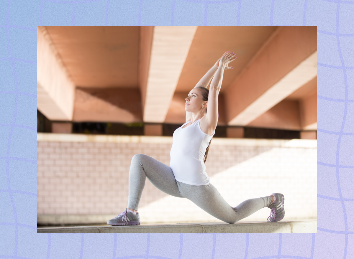 woman doing hip flexor stretch outdoors under bridge during workout