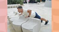 middle-aged man doing elevated pushups outdoors