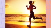 fit woman running on beach at sunset by the water