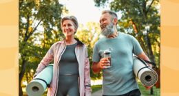 mature couple holding yoga mats walking to fitness class outdoors
