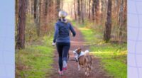 blonde woman running outdoors on trail surrounded by trees with her dog