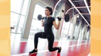 woman doing barbell lunges at the gym in front of windows