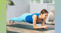 mature woman doing forearm plank on yoga mat in workout class