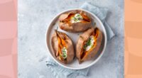 roasted sweet potatoes with sour cream and chives on a plate