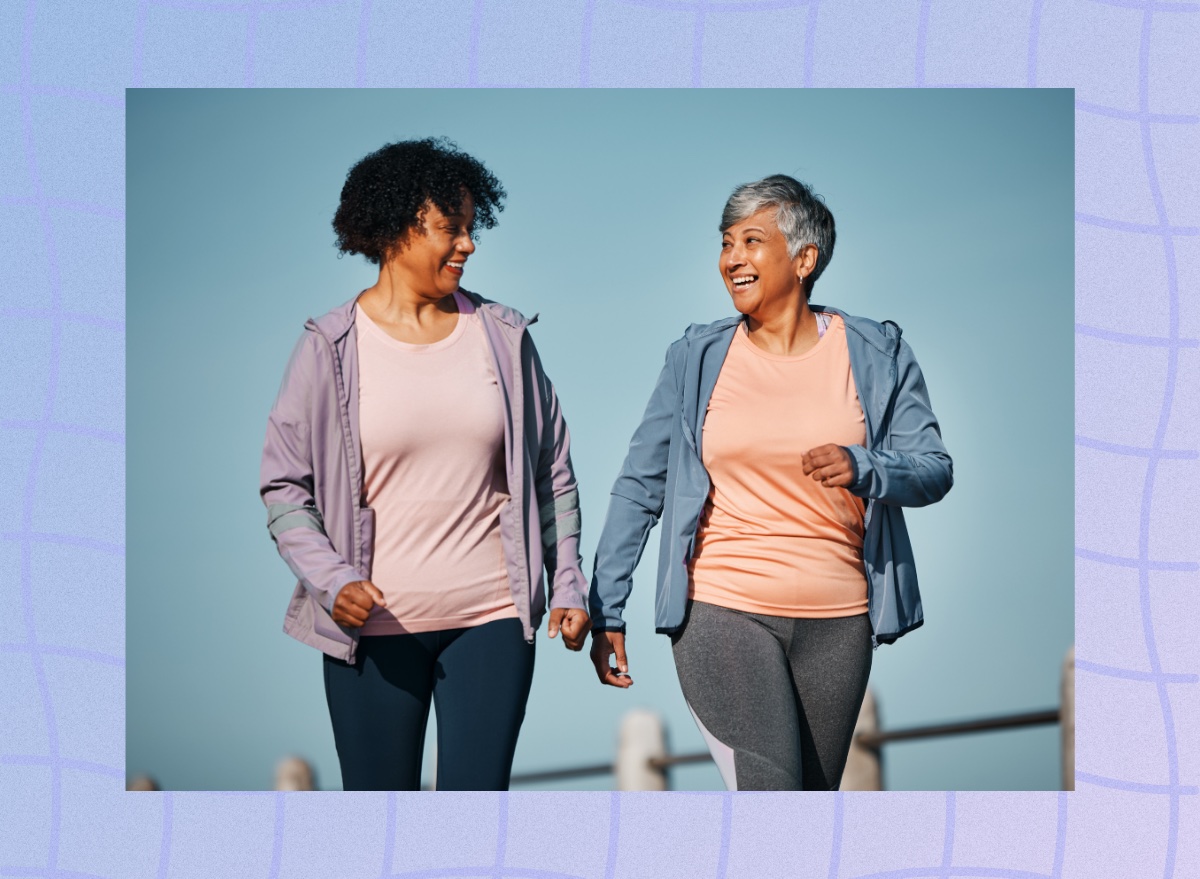 mature female friends walking for exercise outdoors and talking