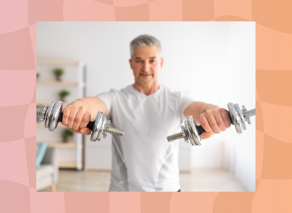 mature man lifting dumbbells at home