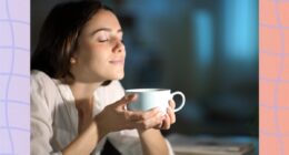 brunette woman holding cup of coffee at night