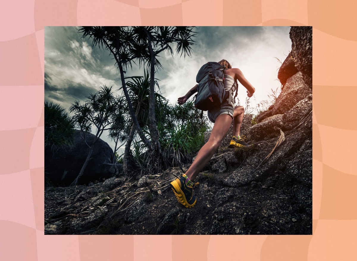 woman rucking uphill through mountain terrain