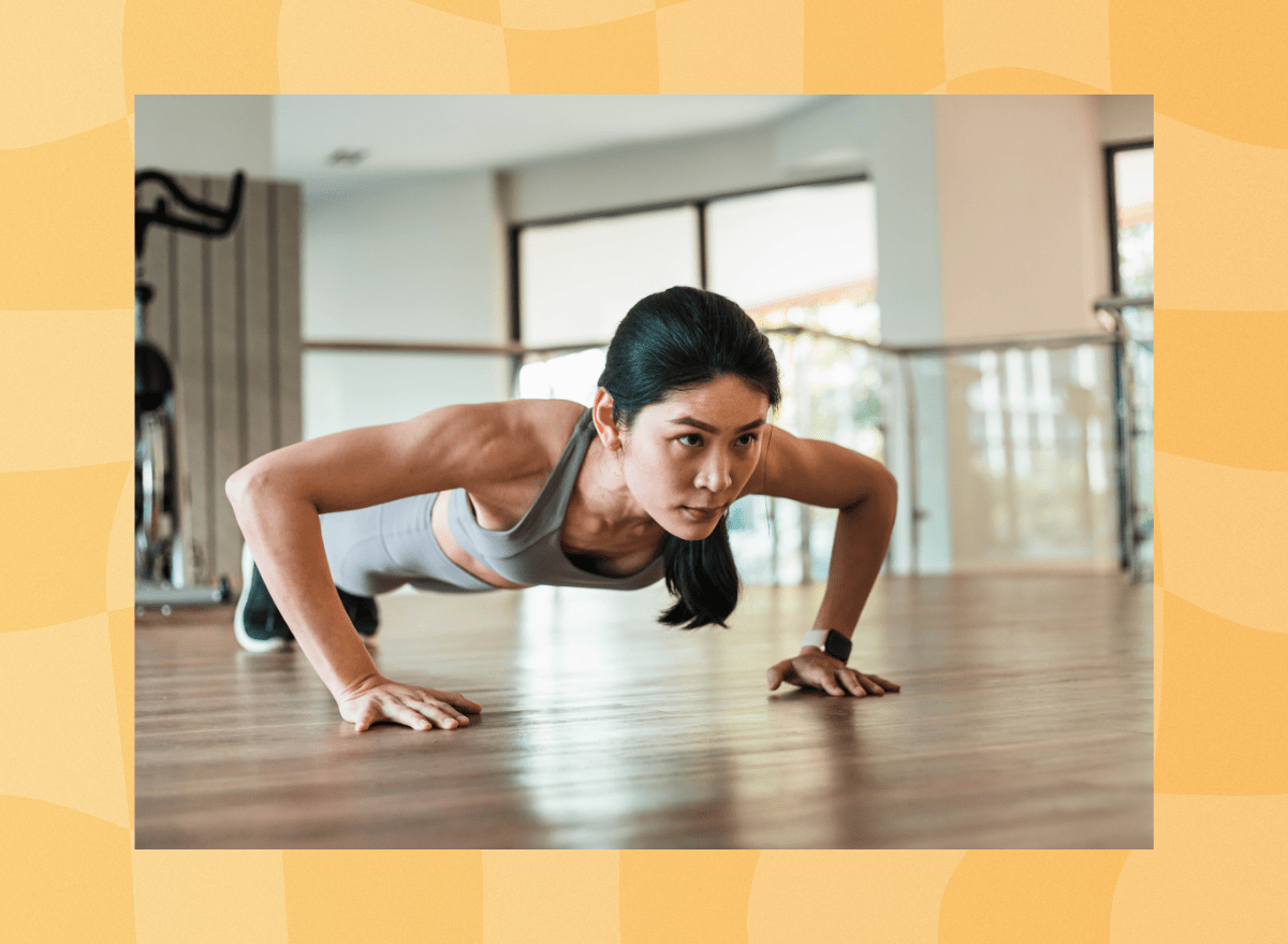 fit woman doing pushups at the gym