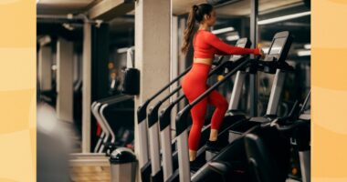 fit woman using a stair climber, StairMaster machine at the gym