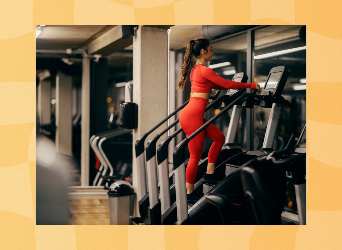 fit woman using a stair climber, StairMaster machine at the gym