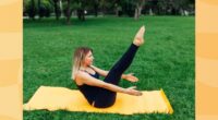 focused woman doing V-up exercise on yellow yoga mat on yawn