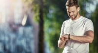 man checking his heart rate monitor on walk/run