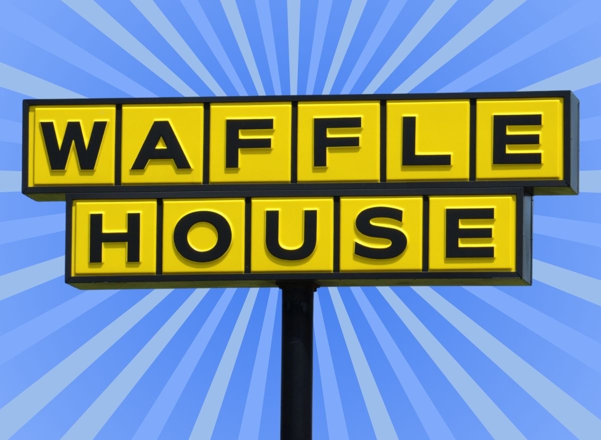 The iconic yellow sign f a Waffle House restaurant set against a vibrant blue background