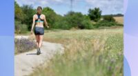 brunette woman walking outdoors on trail