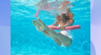 fit woman doing water aerobics exercises in the pool