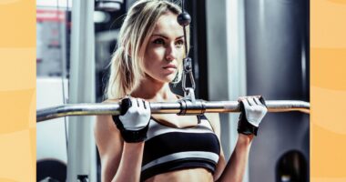 woman doing lat pulldown exercise at the gym