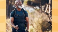 mature man hiking outdoors on grassy trail