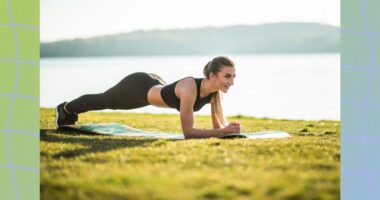 woman holding plank outside on yoga mat