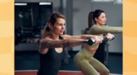 woman lifting lightweight dumbbells in workout class