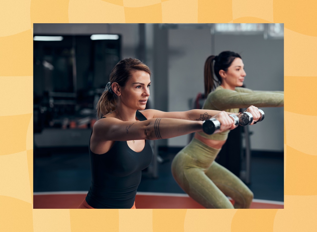 woman lifting lightweight dumbbells in workout class