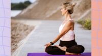 woman doing spinal twist on yoga mat outdoors