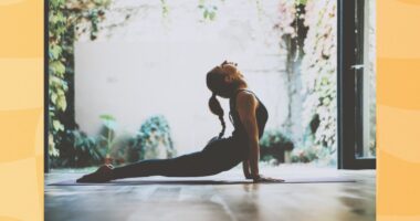 fit woman doing cobra pose in garden living space