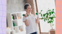 fit, mature woman lifting lightweight dumbbells in a bright living space