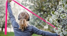 woman doing resistance band exercise outdoors, concept of resistance band workouts to stay active and fit as you age