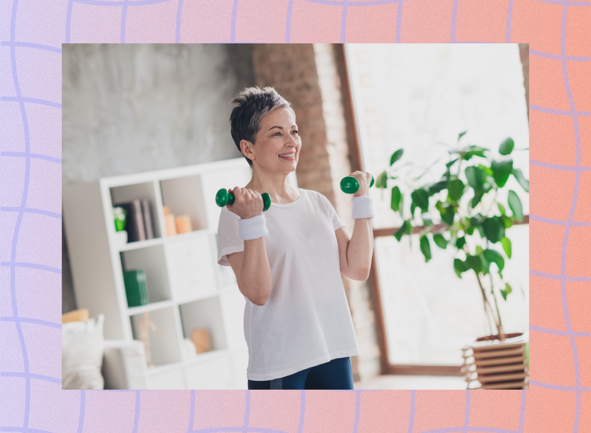 fit, mature woman lifting lightweight dumbbells in a bright living space