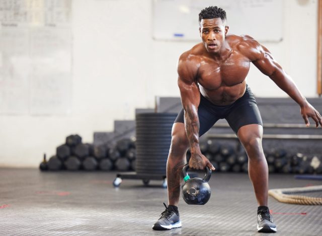 man doing kettlebell row, single-arm