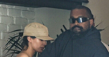 Kanye West attempts to hide wife Bianca Censori from cameras as she steps out wearing a nude sheer top in Los Angeles