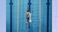 a photo of a man swimming laps in a pool on a designed bluish background