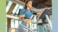 fit woman using an elliptical at the gym