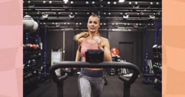 fit, focused woman running on treadmill at the gym