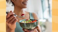 close-up of woman eating healthy yogurt bowl with fruit