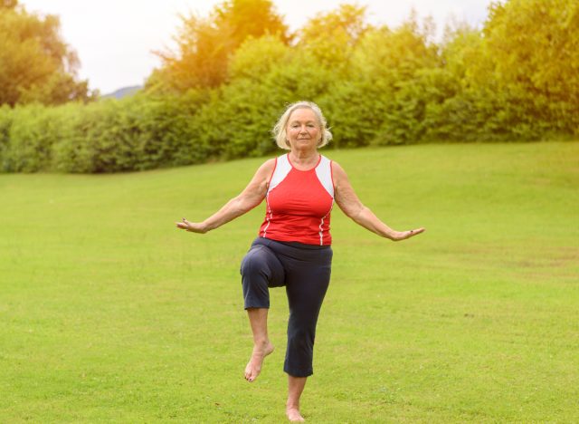 woman demonstrating balance test to predict how long you'll live