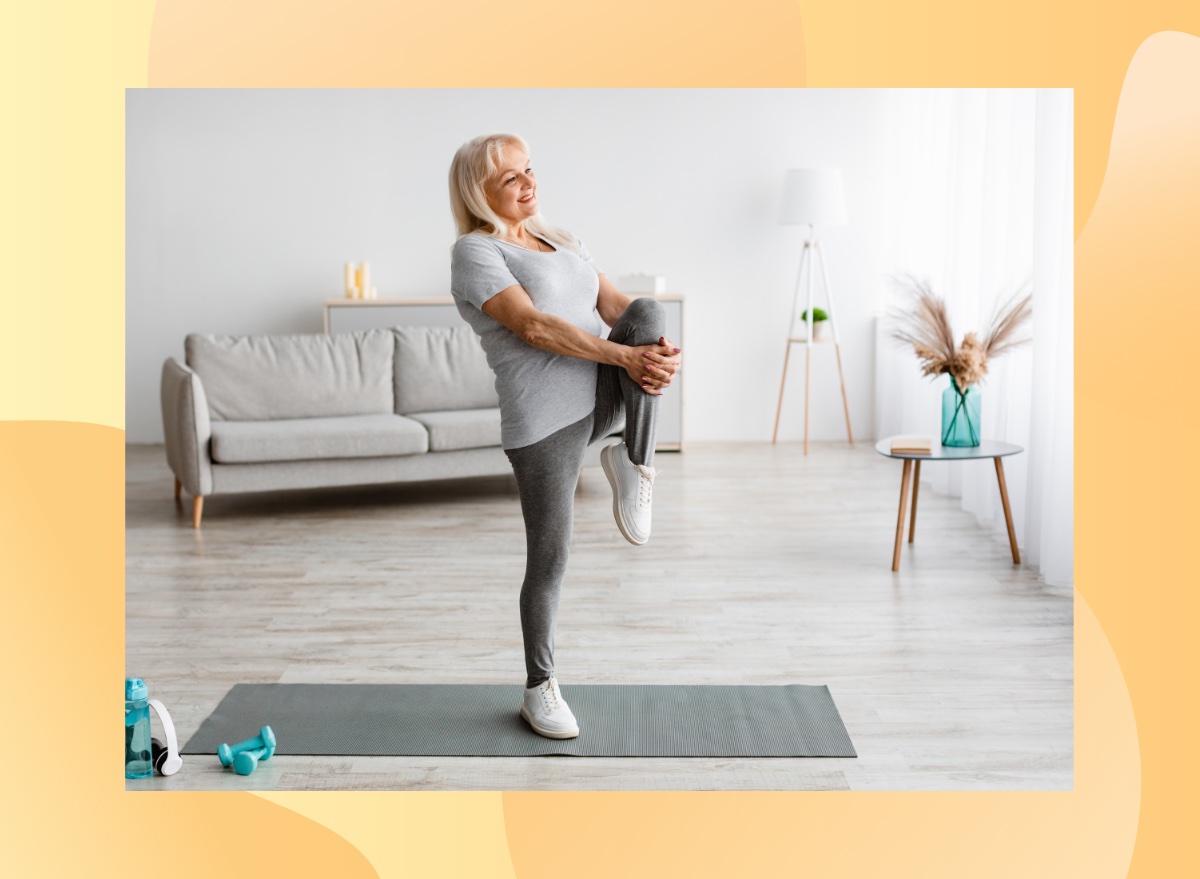 mature woman doing a single-leg balance exercise in bright living space