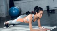 fitness woman doing planks, concept of low-impact exercises for love handles