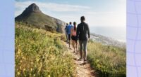 group of hikers walking nature mountain path by the sea