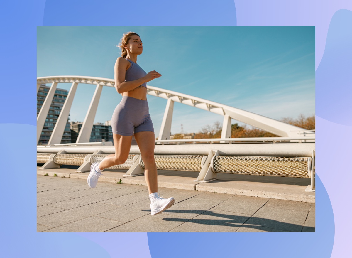 fit woman running outdoors on bridge on sunny day for exercise