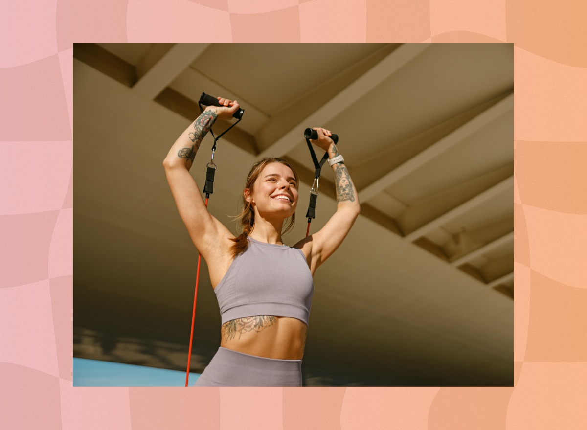 woman performing resistance band workout outdoors