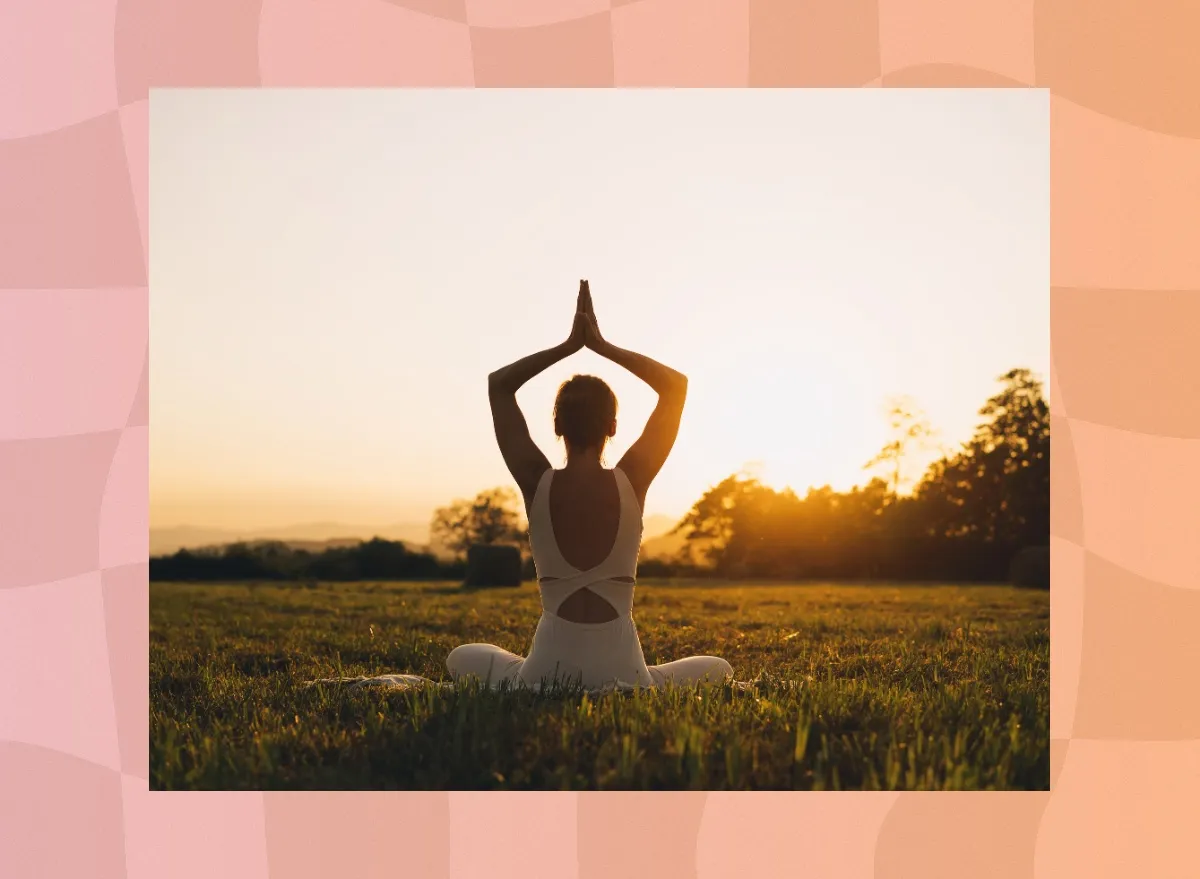 fit woman doing yoga in a field at a sunset