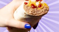 A handheld bean burrito from Taco Bell set against a vibrant purple background.