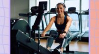 happy, fit woman performing a rowing machine workout in bright gym