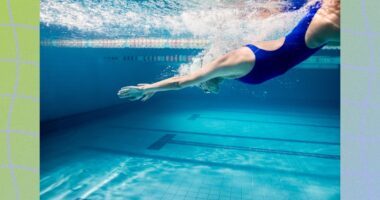 fit swimmer diving into deep end of pool, underwater shot