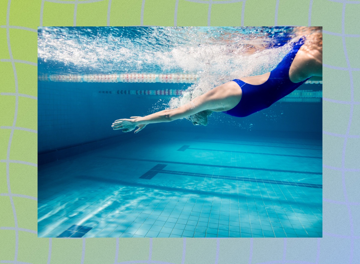 fit swimmer diving into deep end of pool, underwater shot